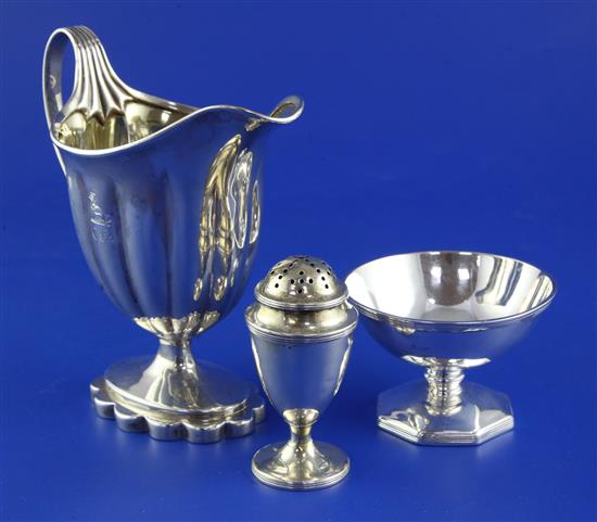 A George III silver helmet shaped cream jug , salt and pepper.